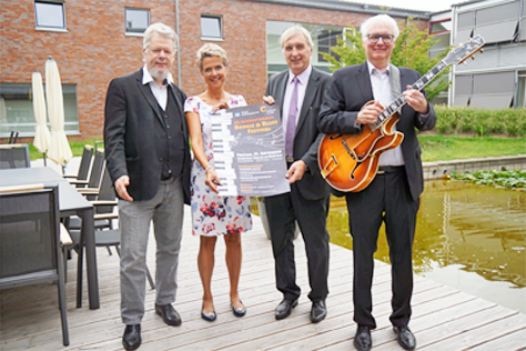 C. Bleiming, A. Evers, T. Borgert, A. Grund mit Plakat Boogie und Blues Festival 2018 