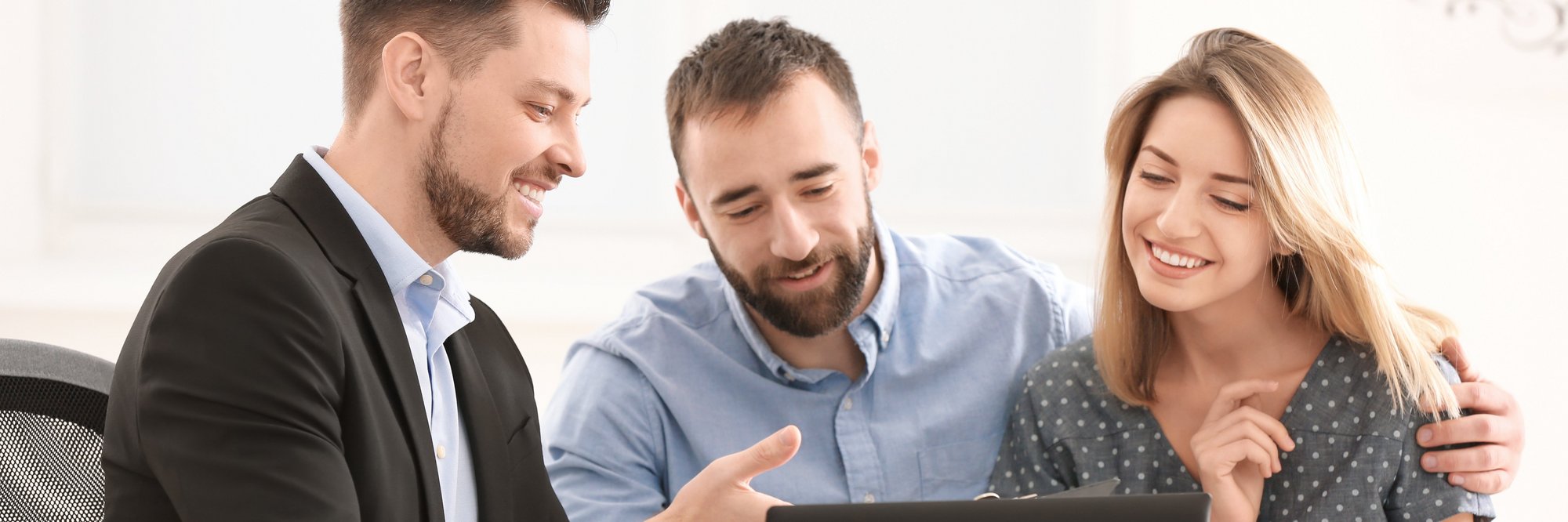 Drei Personen arbeiten gemeinsam am Laptop. Drei Personen arbeiten gemeinsam an einem Laptop und unterhalten sich dabei. Sie wirken freundlich und kooperativ.